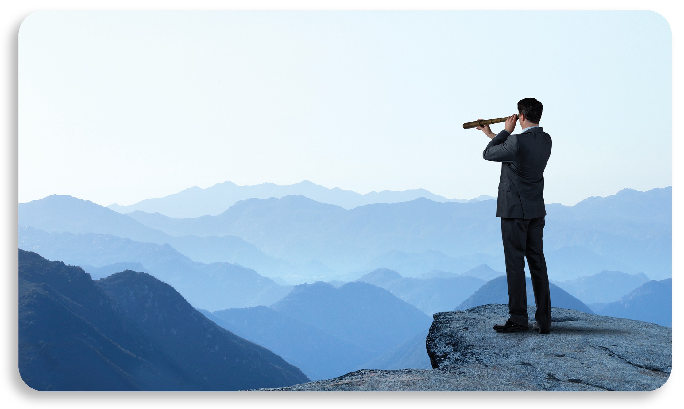 business man on mountain looking out with telescope